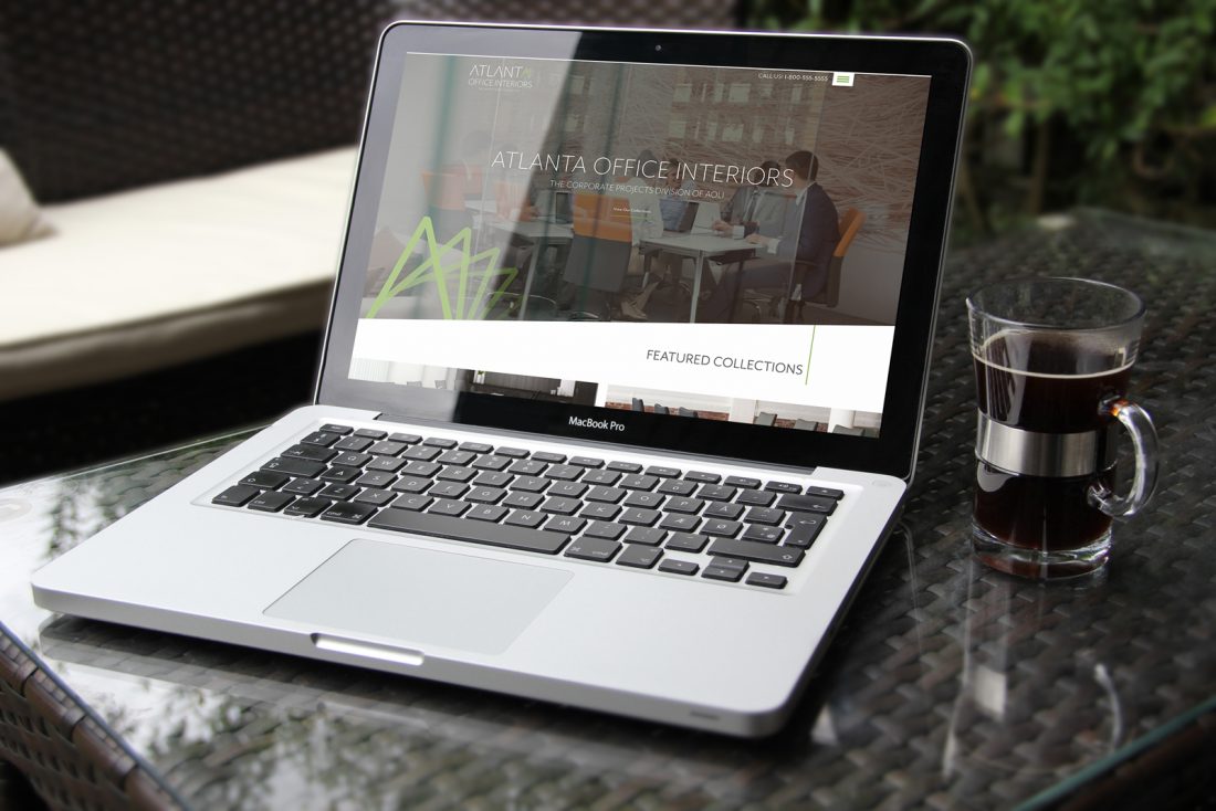 Atlanta Office Interiors website on a laptop